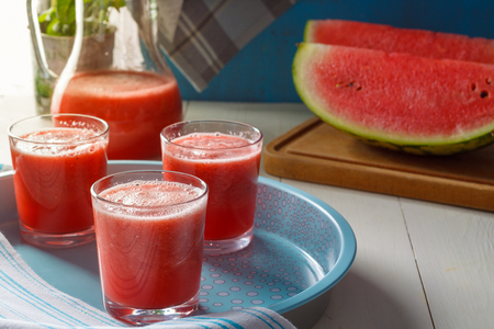 Fresh watermelon smoothies, glasses is standing on wooden table.の写真素材