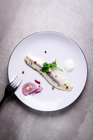Herring fillet with red onion and cream.の写真素材