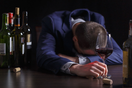 Businessman drunk by wine. Elegant alcoholic.の写真素材