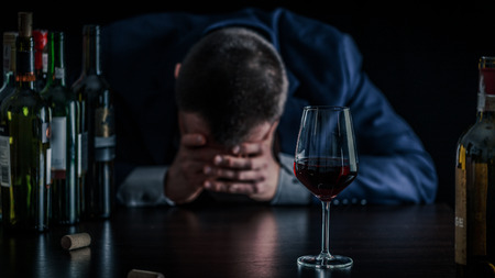 Businessman drunk by wine. Elegant alcoholic.の写真素材
