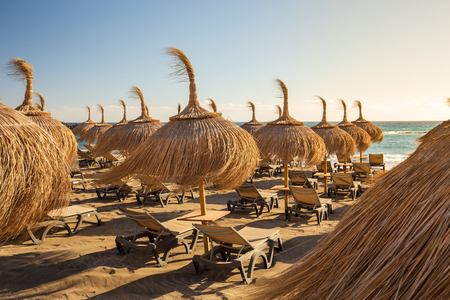 Sun umbrellas Torviscas Beach (Playa de Torviscas), near El Duque Castle, Tenerife, Spain.の写真素材