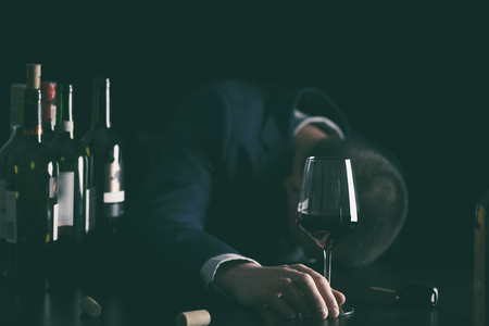 Businessman drunk by wine. Elegant alcoholic.の写真素材