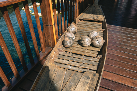 Wooden canoe with old coconuts, vintage photography.の写真素材