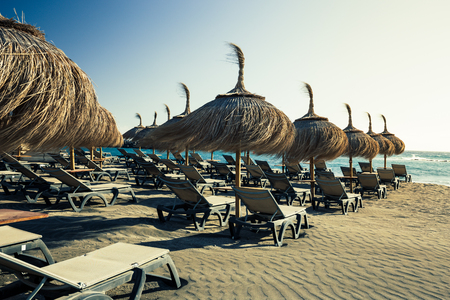 Sun umbrellas at Torviscas beach on costa Adeje in Tenerife Island.の写真素材