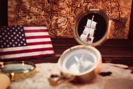 Old vintage maps and marine equipment like compass, magnifier or hourglass and ship. Columbus Day concept.の写真素材