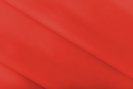 Smooth elegant shiny red silk or satin luxury cloth texture can use as abstract holidays background. Luxurious Christmas background or New Year background design.の写真素材