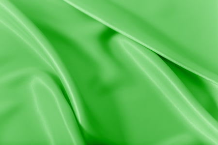 Smooth elegant shiny green silk or satin luxury cloth texture can use as abstract holidays background. Luxurious Christmas background or New Year background design.の写真素材