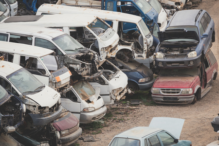 Car junkyard with many forgotten wrecks passenger cars.の写真素材