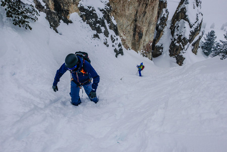 Off-piste skiers are practicing rock climbing.のeditorial素材