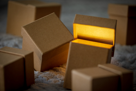 Small cardboard gift boxes with bokeh effect as concept of christmas sale.の写真素材