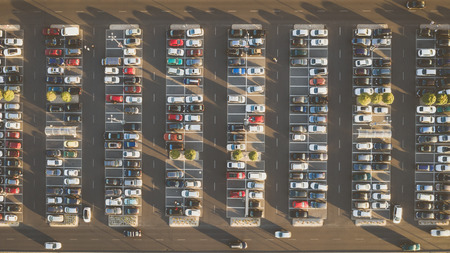 Top down view from drone on mall parking with many cars.の写真素材