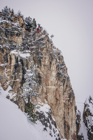 Off-piste skiers are practicing rock climbing.の写真素材