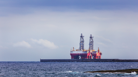 Two masts of oil rig on sea near coastline.の写真素材