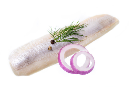 Herring flap with oil, pepper, dill and onion isolated on white.の写真素材