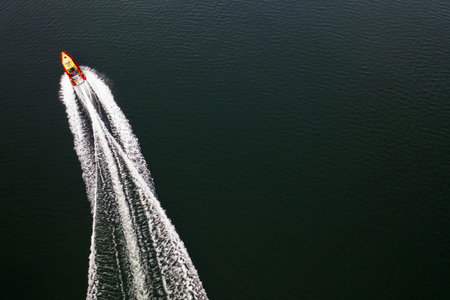 Top down view on speed movement of rescue motorboat.