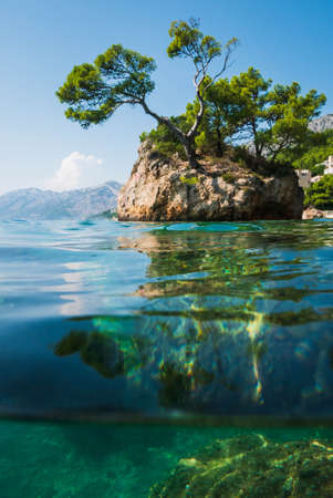 Semi underwater photography of holiday resort Brela in Croatia, famous Brela Rock, Punta Rata Beach, Makarska Riviera.の写真素材