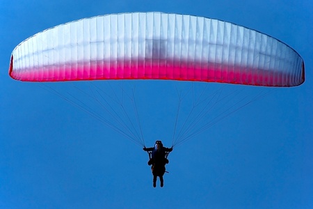 tandem paragliding in the blue sky, flying in the skyの写真素材