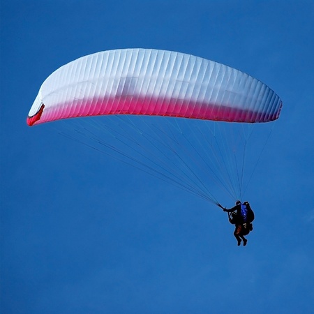tandem paragliding in the blue sky, flying in the skyの写真素材