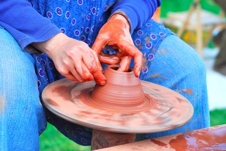 Production on the potter's wheel, hand detail of pottery techniqueの写真素材