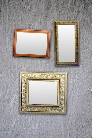 empty frames for photos hanging on the white wallの写真素材