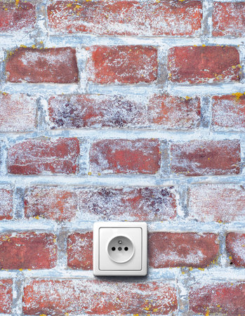 old red brick wall with electrical outlet