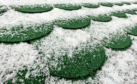 roof in winter on which lies snow, roofing of shinglesの写真素材
