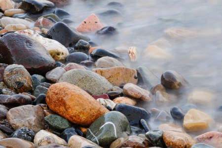 Wet stones with long exposure in seaの写真素材