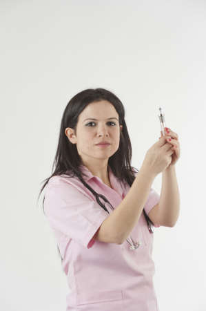 Nurse with stethoscope ready for injectionの写真素材