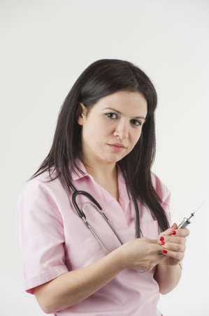 Nurse with stethoscope ready for injectionの写真素材