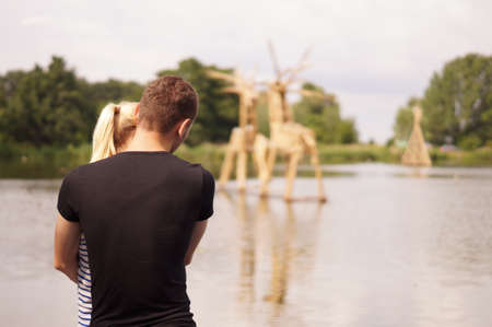 Young couple near lakeの写真素材