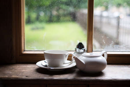 Tea cup pot and sugar on wood tableの写真素材