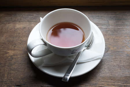 Tea cup and tea from upside on wood tableの写真素材