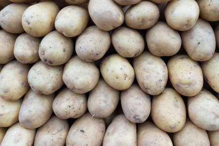 Fresh Organic Potatoes Stack on Market Stall の写真素材