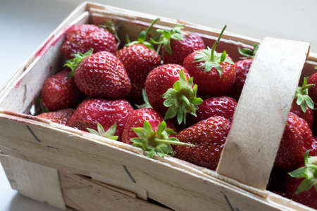 Organic Strawberries in Wooden Basket Ready For Saleの写真素材