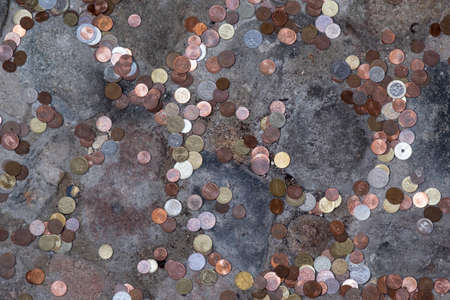 Colorful lCoins Spreaded to Rock Floorの写真素材