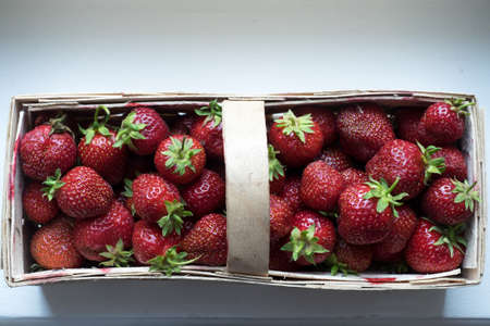 Organic Strawberries in Wooden Basket Ready For Saleの写真素材