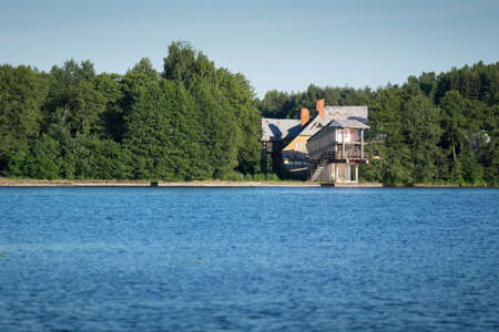Modern Building near by Water Lake in Trakai Lithuania with Boat and Peopleの写真素材