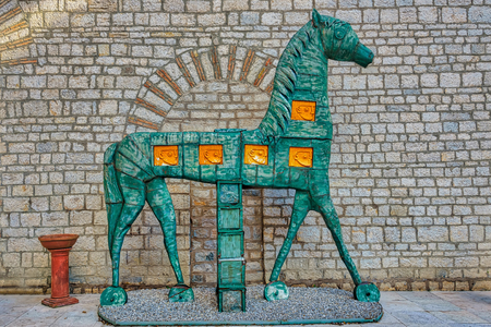 A historic horse figure in front of a medieval wallの写真素材