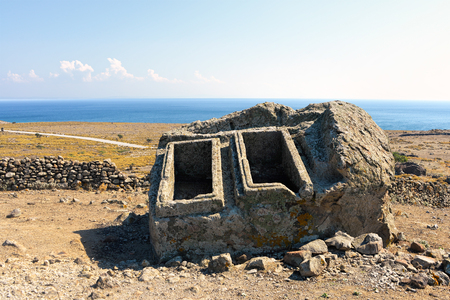 Long forgotten empty ancient tombs in an aegean island of Turkey under clear blue skiesの写真素材