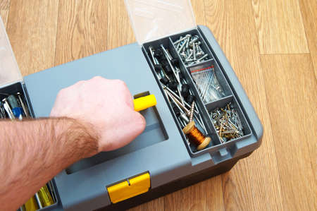 box with a set of household tools on a wooden backgroundの写真素材