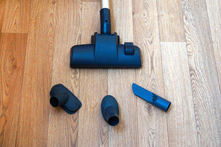 vacuum cleaner nozzle and three on the wooden floorの写真素材