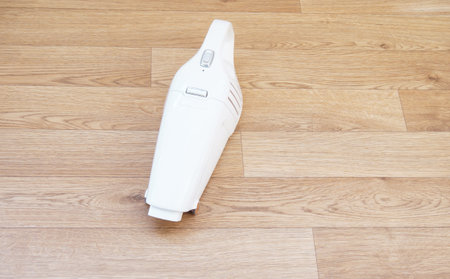 wireless vacuum cleaner on the wooden floorの写真素材