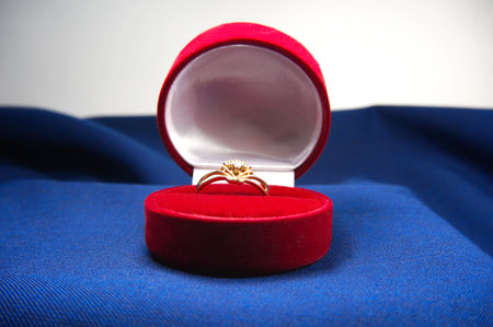 diamond ring with gold in box on velvet background