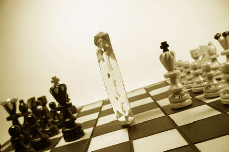 chess pieces, separated by a crystal polyhedronの写真素材