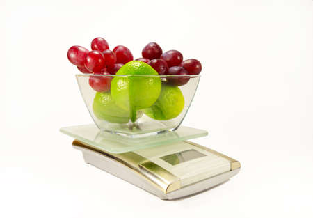 electronic kitchen scales with fruit isolatedの写真素材