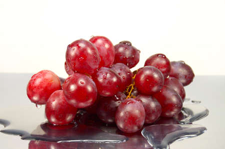 grapes in drops of water on the mirror surfaceの写真素材