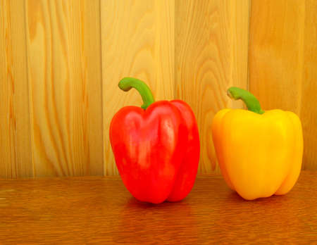 two sweet peppers on a wooden backgroundの写真素材