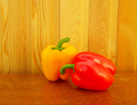 red and yellow peppers on a wooden backgroundの写真素材
