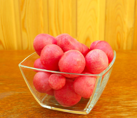 a dish with red radish on the tableの写真素材