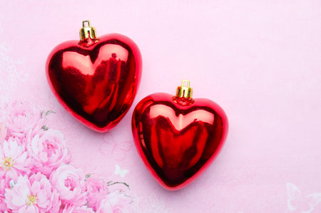 Two glass hearts on a pink backgroundの写真素材